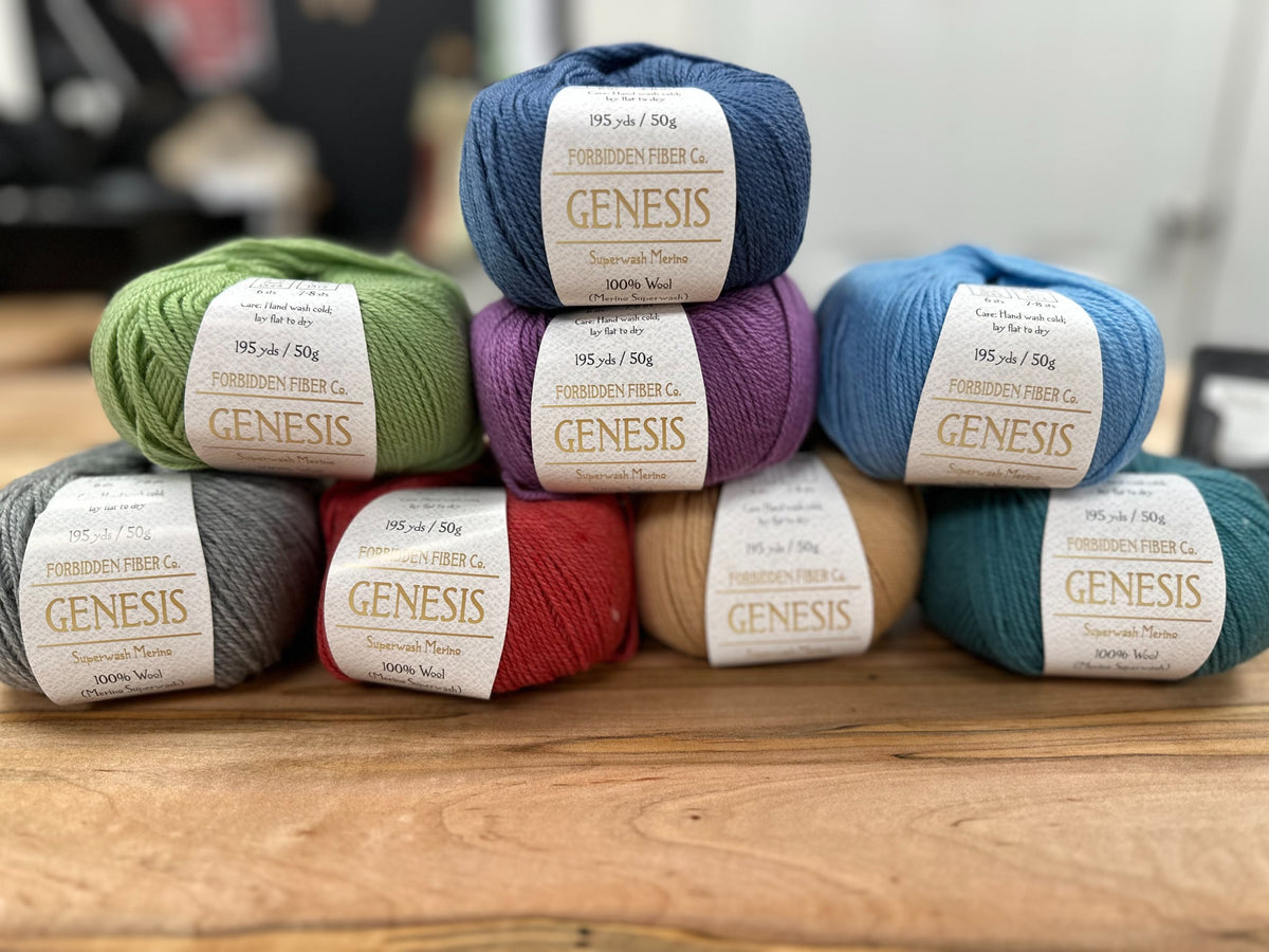 Forbidden Fiber Co. Genesis yarn in eight colorways, photographed in store